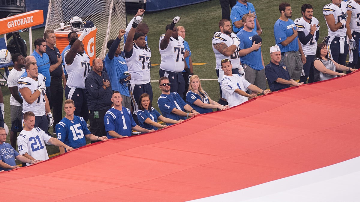 San Diego Chargers players raise their fist during the national anthem 