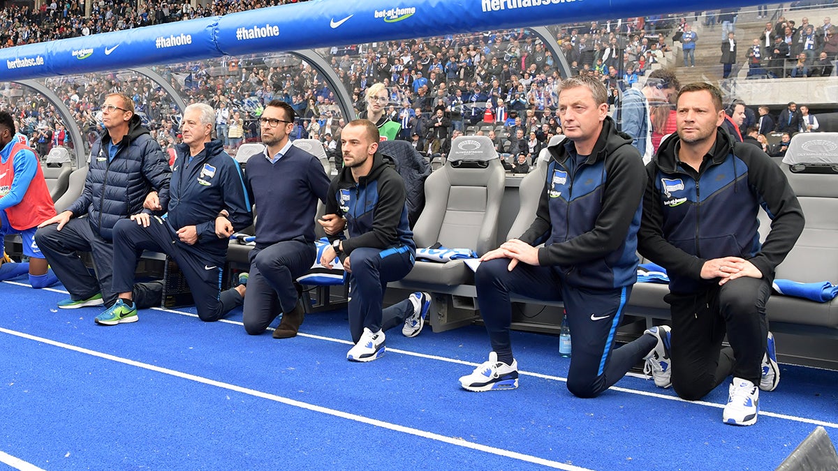 The substitutes' bench of Hertha BSC protest against Donald Trump #TakeaKnee in Berlin 2017