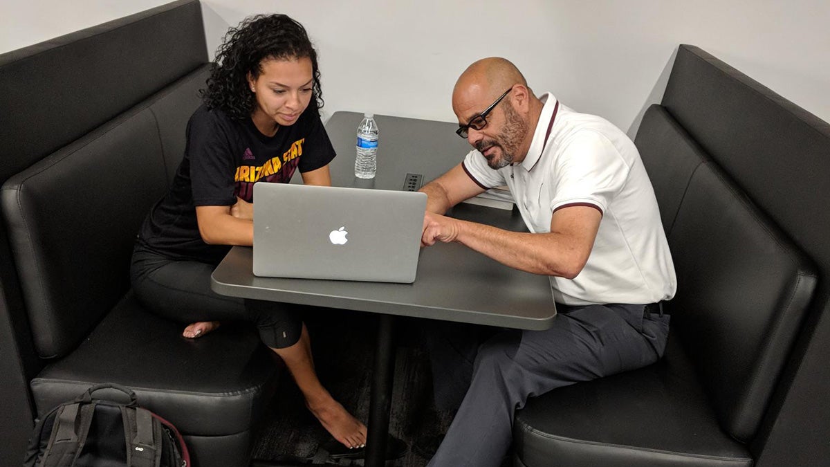 Mentor sitting with student-athlete to help