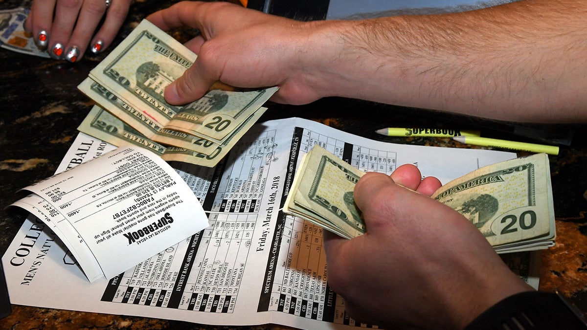 Money is handled during an NCAA tournament by a man in Las Vegas, Nevada