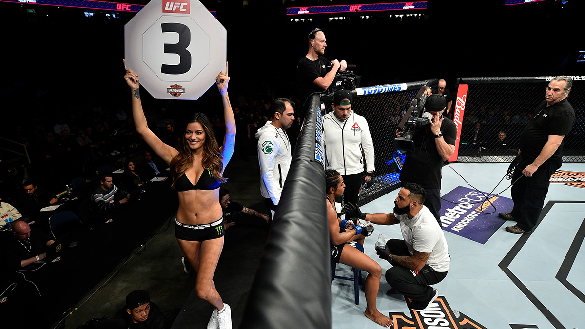 UFC Octagon Girl Vanessa Hansen lifting a Round 3 sign to the crowd during UFC Fight Night