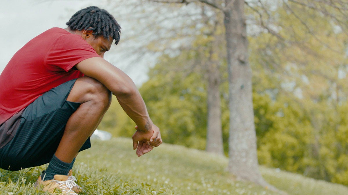 Jalen Ramsey sitting in grass with trees in background