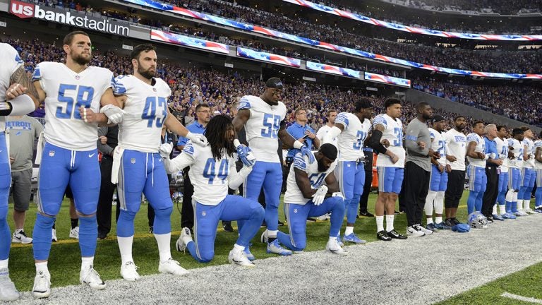 Jalen Reeves-Maybin and Steve Longa of the Detroit Lions of the NFL kneel during the national anthem to protest