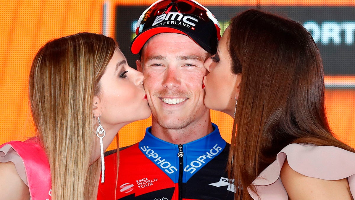 BMC rider Rohan Dennis kissed on cheeks by two women after Tour of Italy cycling race