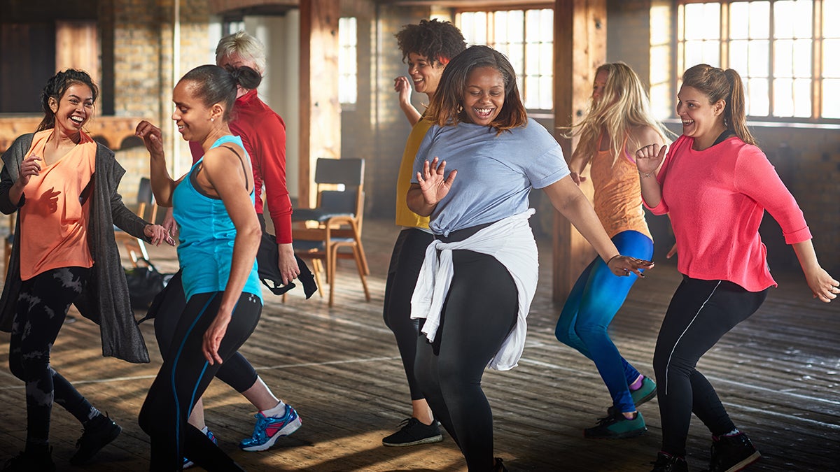 People, fitness and stretching in class at gym for workout, squat exercise  or training together. Diverse