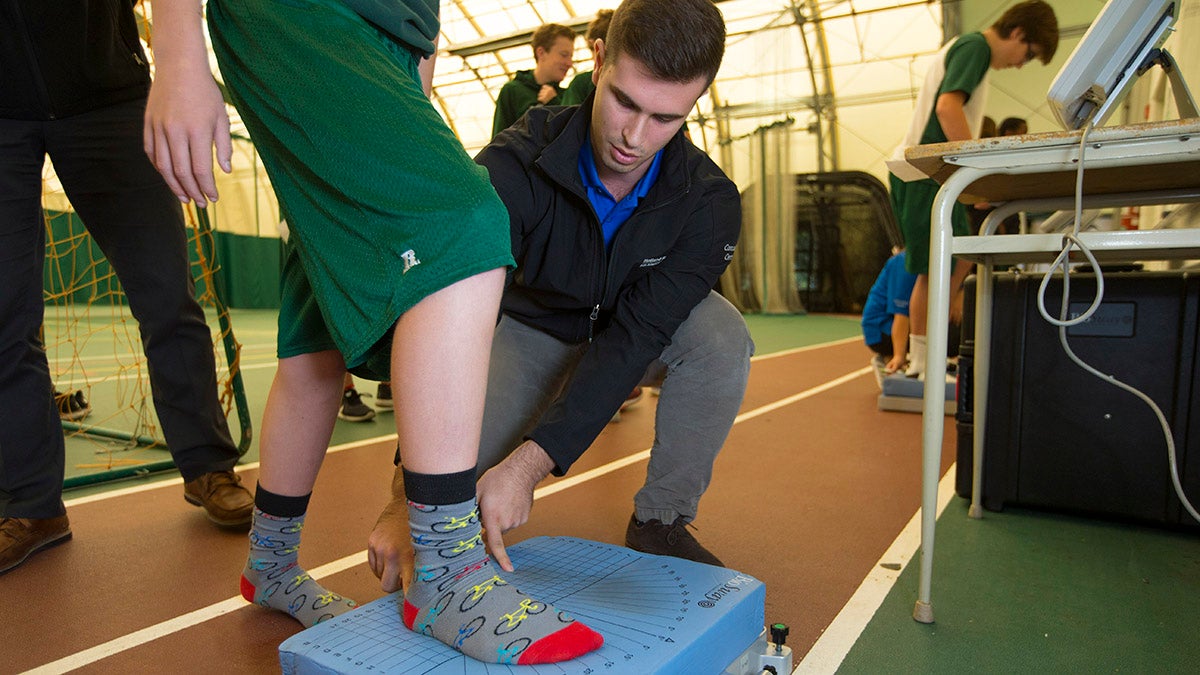 A student gets tested on their balance during a concussion test