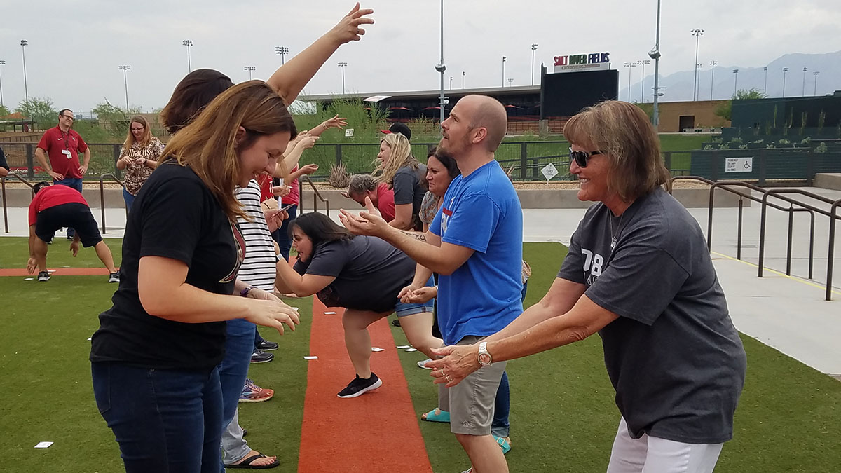 science of sport event tests teacher agility with trading card game outside
