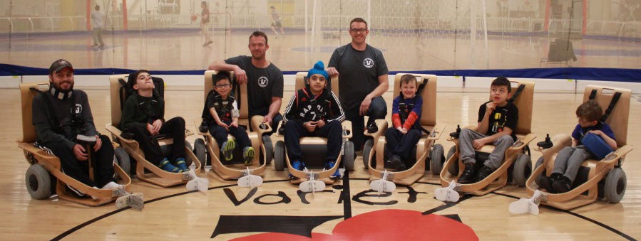 disabled youths play indoor adaptive floor hockey 