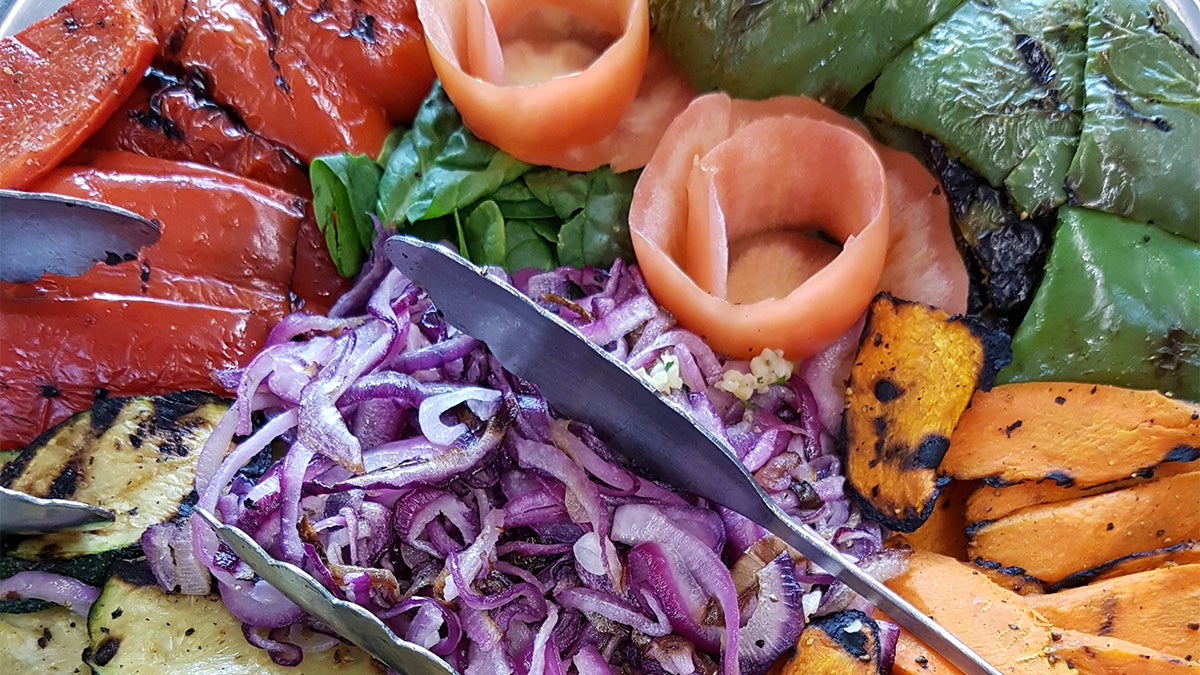 Vegetable medley of peppers sweet potato green pepper zucchini spinach red cabbage and tomato