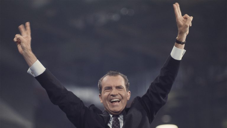 Former President Richard Nixon smiling and waving