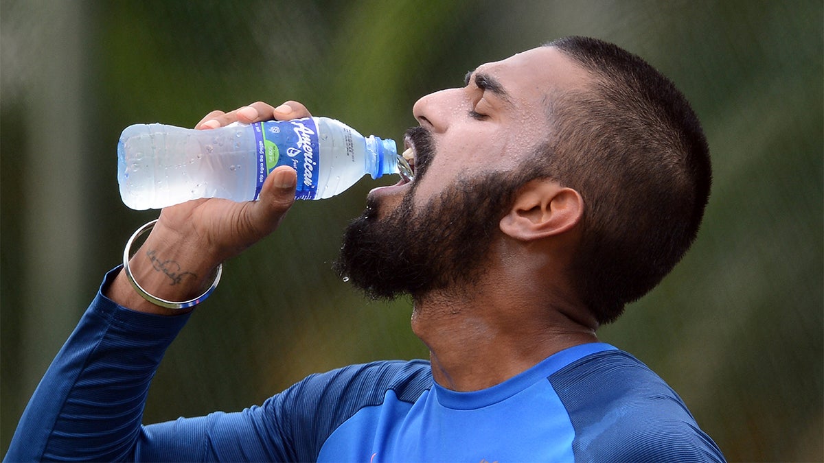 someone taking a sip of water stock image