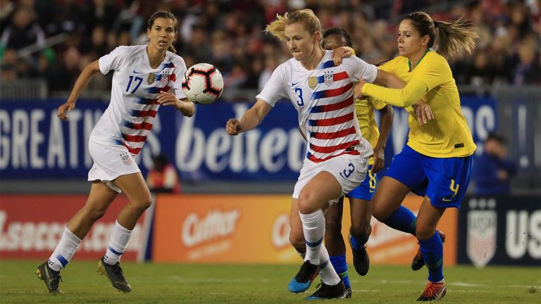 Samantha Mewis of USA soccer team looks to pass the ball over Erika of Brazil during the She Believes Cup in 2019