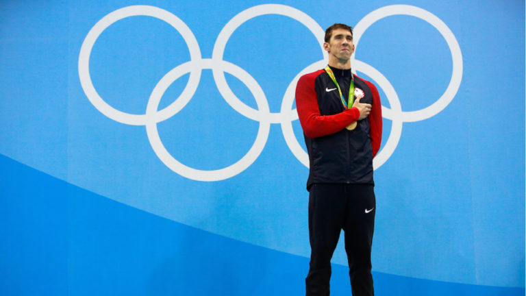 RIO DE JANEIRO, BRAZIL - AUGUST 09: Gold medalist Michael Phelps of the United States poses on the podium during the medal ceremony for the Men's 200m Butterfly Final on Day 4 of the Rio 2016 Olympic Games at the Olympic Aquatics Stadium on August 9, 2016 in Rio de Janeiro, Brazil. (Photo by Adam Pretty/Getty Images)