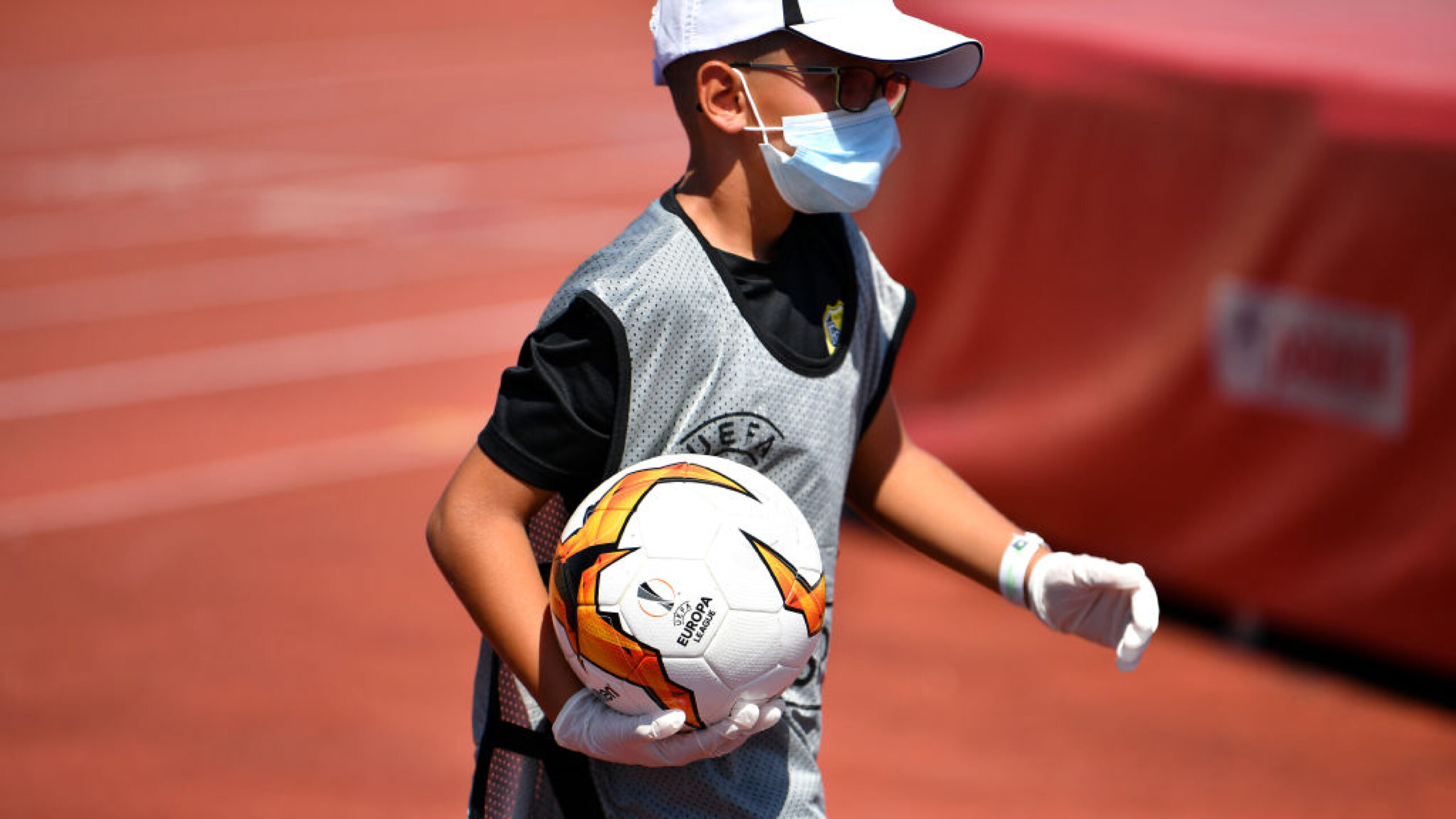 NYON, SWITZERLAND - AUGUST 08: S.S. A ball boy wearing protective equipment on during the UEFA Champions League 2020/21 Preliminary Round Semi-final match between S.S. Tre Fiori F.C. and Linfield FC at Colovray Sports Center on August 8, 2020, in Nyon, Switzerland (Photo by Harold Cunningham - UEFA/UEFA via Getty Images)