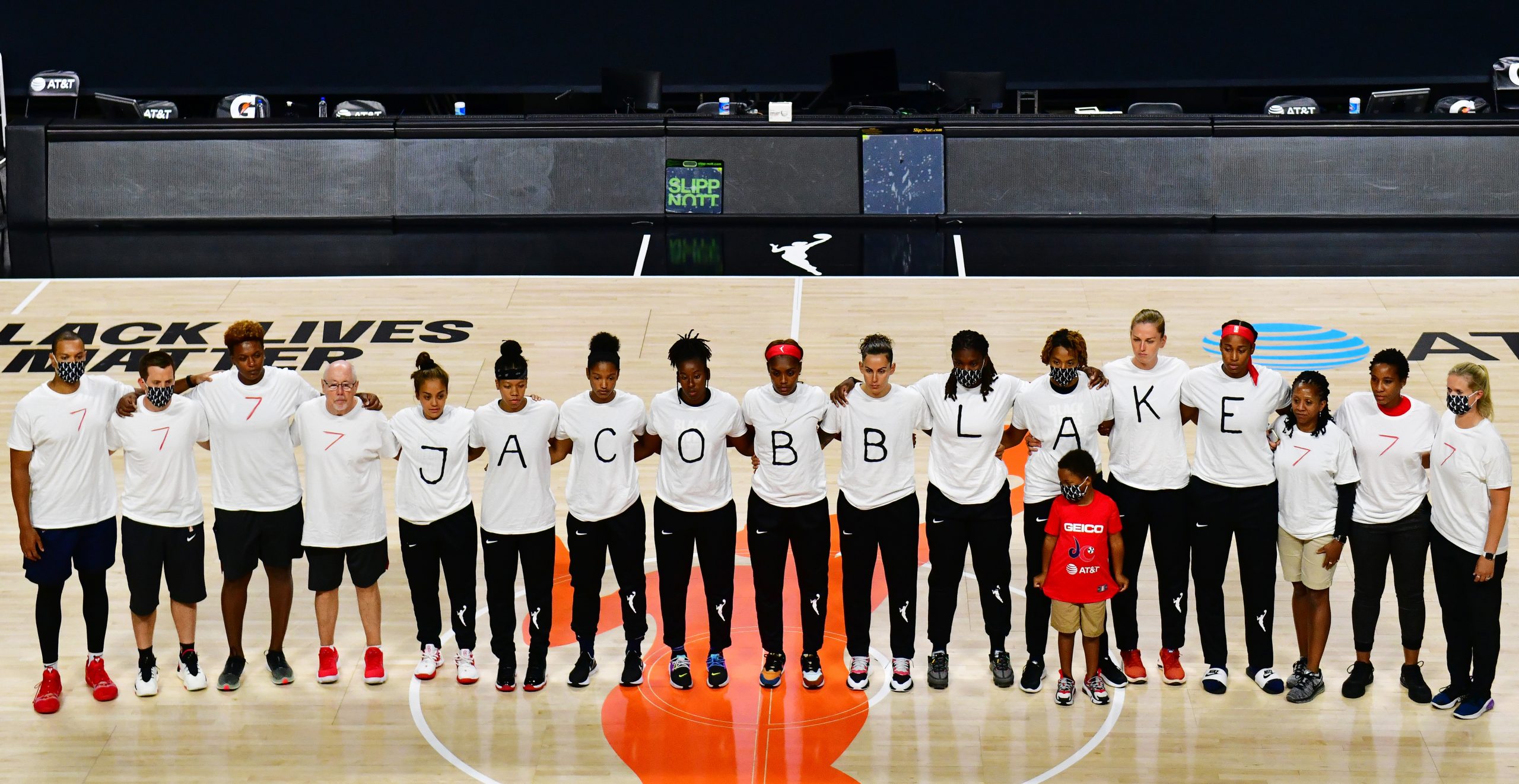 PALMETTO, FLORIDA - AUGUST 26: After the WNBA announcement of the postponed games for the evening, the Washington Mystics each wear white T-shirts with seven bullets on the back protesting the shooting of Jacob Blake by Kenosha, Wisconsin police at Feld Entertainment Center on August 26, 2020 in Palmetto, Florida. NOTE TO USER: User expressly acknowledges and agrees that, by downloading and or using this photograph, User is consenting to the terms and conditions of the Getty Images License Agreement. (Photo by Julio Aguilar/Getty Images)