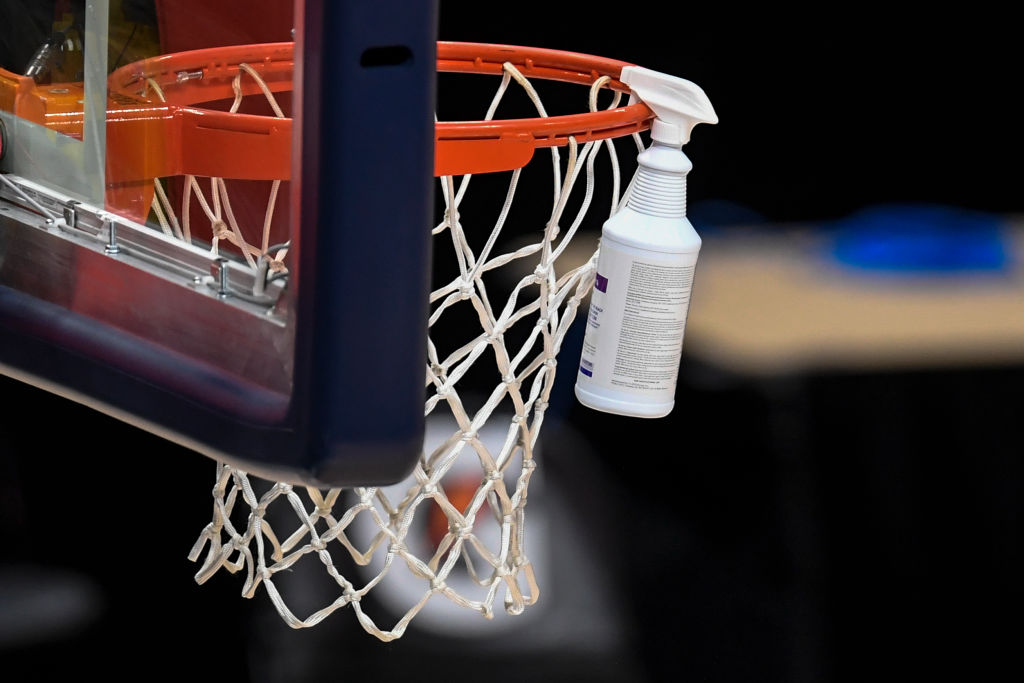 DENVER, CO - FEBRUARY 1: Antonio Escobedo cleans the glass as he and fellow crew sanitize after cancellation due to ongoing contact tracing within the Detroit Pistons locker room left the arena silent before tipoff against the Denver Nuggets on Monday, February 1, 2021.(Photo by AAron Ontiveroz/MediaNews Group/The Denver Post via Getty Images)
